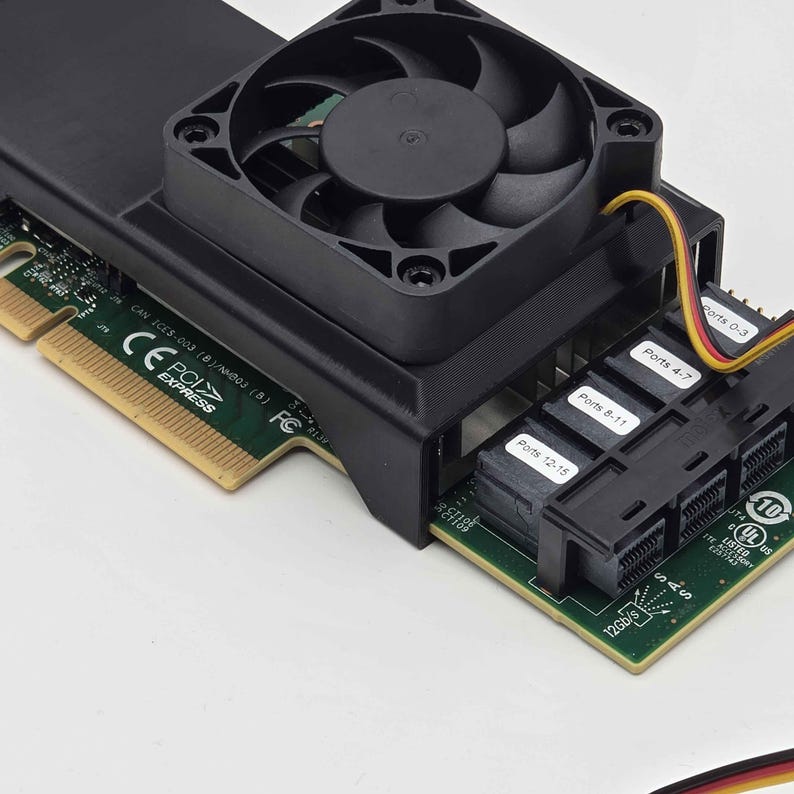 May include: A black computer component with a fan, ports, and a green circuit board. The component has labels for "Ports 0-3", "Ports 4-7", "Ports 8-11", and "Ports 12-15". The component also has the text "PCI EXPRESS" and "SAS 12Gb/s".