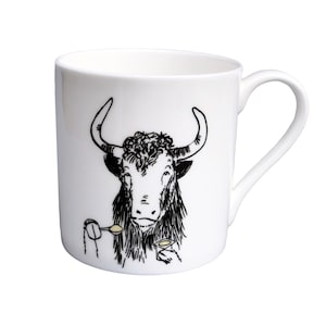 May include: White ceramic mug featuring a black and white illustration of a yak enjoying a pot of yogurt with a spoon.