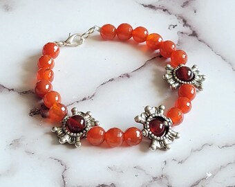 Carnelian bracelet with two toned carnelian gemstone beads and silver sunburst accents