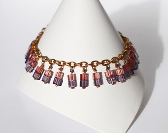 Gold bracelet with purple cube bead dangles "Peacock"