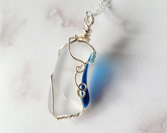 Wire wrapped art glass pendant with translucent blue, on a silver chain