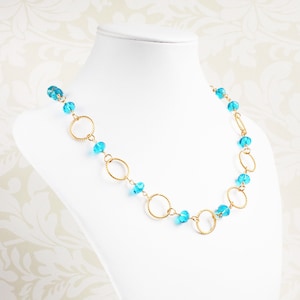 Aqua blue crystal and gold hoop necklace with handmade wire links