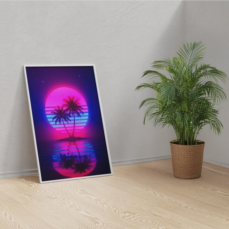 May include: A framed art print featuring a retro sunset scene with palm trees. The artwork showcases a vibrant pink and purple sun, blue water, and a dark blue sky. The print is displayed on a wooden floor next to a potted plant.