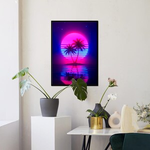 May include: A framed art print featuring a neon sunset scene with palm trees. The artwork showcases a vibrant pink and blue color palette, with the sun's reflection in the water. The image has a retro, vaporwave aesthetic.