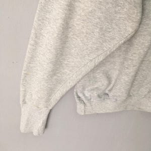 Puede incluir: Una sudadera de color gris jaspeado claro que presenta mangas largas con pu&ntilde;os acanalados y un dobladillo acanalado. La prenda est&aacute; confeccionada con un tejido suave y texturizado con un dise&ntilde;o de cuello redondo cl&aacute;sico y funcional.