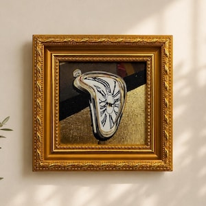 May include: A square wall art piece featuring a melting clock motif with black Roman numerals on a white face, set against a background of black and gold textured panels. The artwork is encased in a decorative, ornate gold-colored frame.