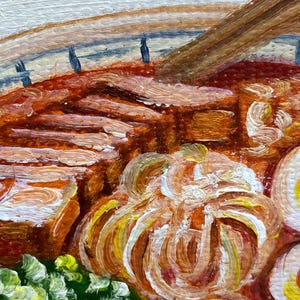 May include: An oil painting depicting a bowl of ramen with thick slices of brown pork, a soft-boiled egg with a yellow yolk, and a cluster of green scallions. The broth is a deep reddish-orange color, and a wooden spoon rests inside the bowl.