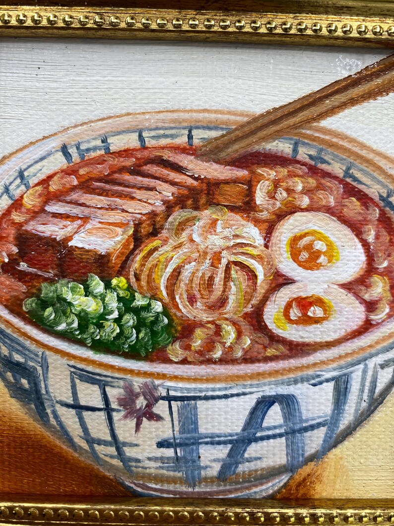 May include: An oil painting of a bowl of ramen featuring a red broth, sliced pork belly, a soft-boiled egg cut in half, and green onions. A pair of wooden chopsticks rests in the bowl. The ceramic bowl has a blue and white grid pattern.