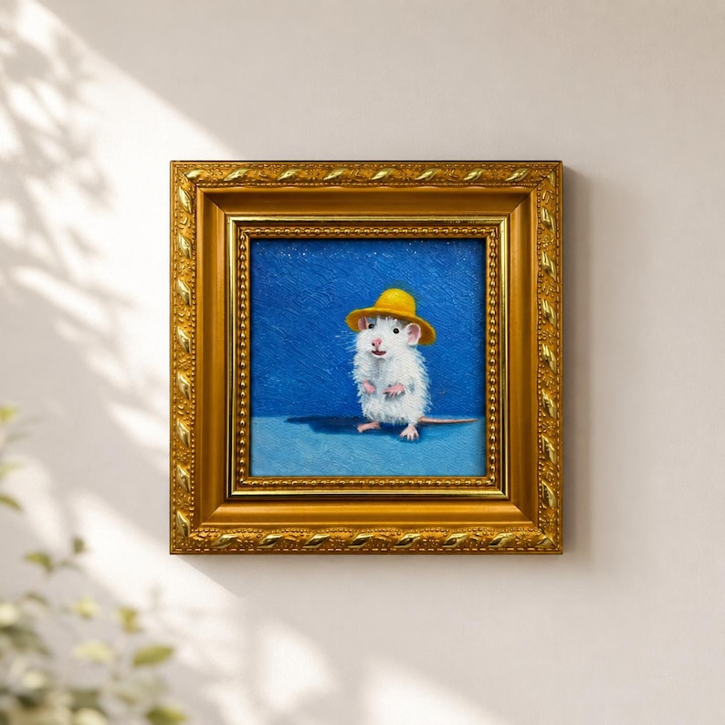 May include: A square oil painting in a decorative gold frame featuring a white mouse wearing a small yellow hat. The mouse stands on a light blue surface against a textured dark blue background, rendered with visible brushstrokes and fine detail.