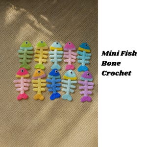 May include: A collection of colorful, crocheted fish bone ornaments. The ornaments are in various colors, including green, yellow, pink, blue, and purple. The text "Mini Fish Bone Crochet" is displayed in black.
