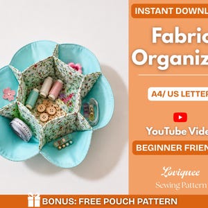 May include: A flower-shaped fabric organizer with six compartments, featuring a light blue exterior and a floral interior print. It contains sewing supplies like thread spools, buttons, and a measuring tape. Text includes INSTANT DOWNLOAD Fabric Organizer A4/ US LETTER YouTube Video BEGINNER FRIENDLY Loviquee Sewing Pattern BONUS: FREE POUCH PATTERN.