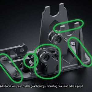 May include: A gray mechanical component featuring a base with mounting holes, vertical supports, and gear bearings. Green outlines highlight specific areas, and the text reads: Additional lower and middle gear bearings, mounting holes and extra support.