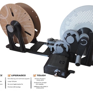 May include: A black and gray 3D printer filament spool holder with two spools. The holder features gears, a handle, and a power switch. Text on the image includes "CONVENIENCE", "UPGRADES", and "TOUGH".