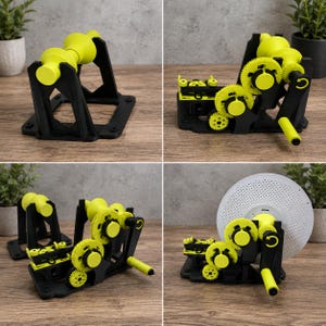 May include: A mechanical device featuring a black frame and bright yellow gears, including a hand crank and a central spindle. The assembly includes a series of interlocking cogs and a circular white perforated disc attached to the central axis.