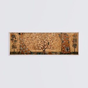 May include: A framed print of Gustav Klimt's "The Tree of Life, Stoclet Frieze." The artwork features a central tree with swirling branches and gold and brown tones. Two figures stand on either side of the tree, with additional trees on the edges.
