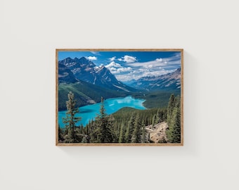 May include: A framed landscape print featuring a vibrant turquoise lake surrounded by lush green forests and towering, snow-capped mountains under a bright blue sky with fluffy white clouds. The artwork is encased in a wooden frame.