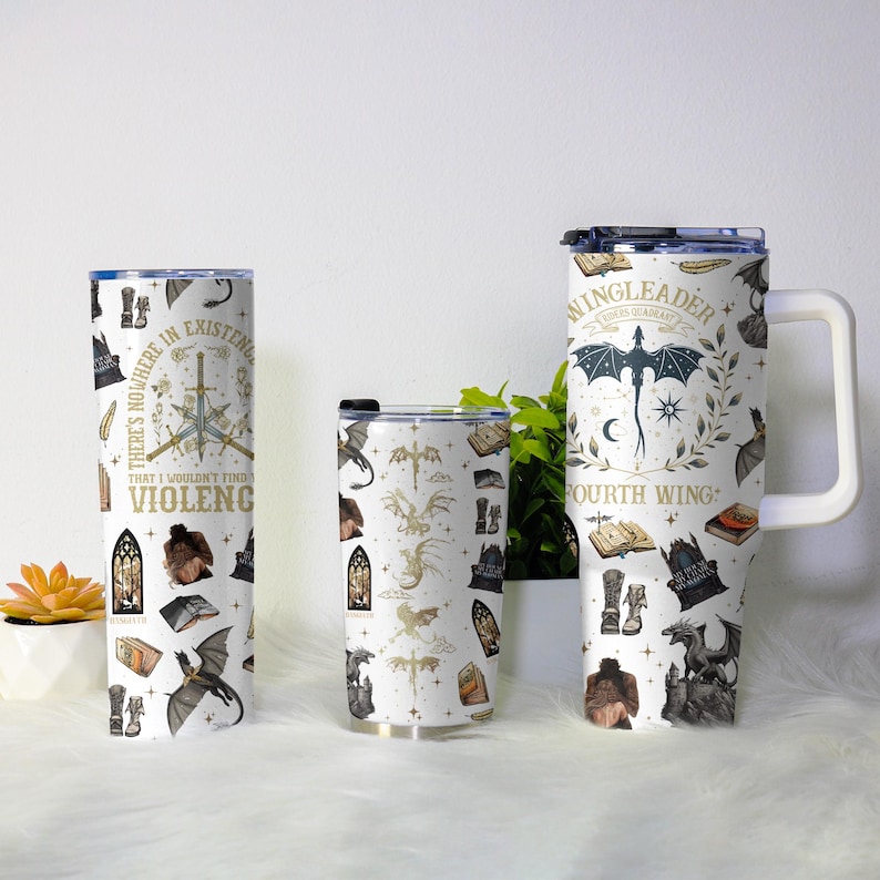 May include: Three white insulated tumblers with black lids and a white handle. The tumblers are covered in a repeating pattern of dragons, books, and text. The text on the tumblers reads "THERE'S NOWHERE IN EXISTENCE THAT I WOULDN'T FIND VIOLENCE" and "WINGLEADER FOURTH WING".