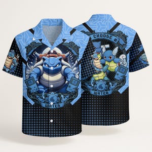 May include: A short-sleeve button-down shirt in shades of blue and black featuring a graphic print of the character Blastoise. The design includes the text CHOOSE WATER, handheld gaming consoles, and a repeating geometric pattern on the collar.