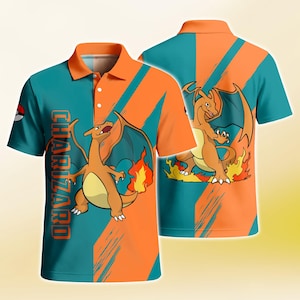 May include: A short-sleeved polo shirt featuring a teal and orange diagonal striped pattern. The shirt displays a graphic of the orange dragon-like creature Charizard with flames, and the text CHARIZARD printed vertically in orange letters.