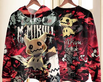 May include: A long-sleeve hoodie and a sweatshirt featuring a graphic print of the character Mimikyu. The design includes red and black abstract patterns, the text "MIMIKYU" in a stylized font, and Japanese characters printed on the fabric.