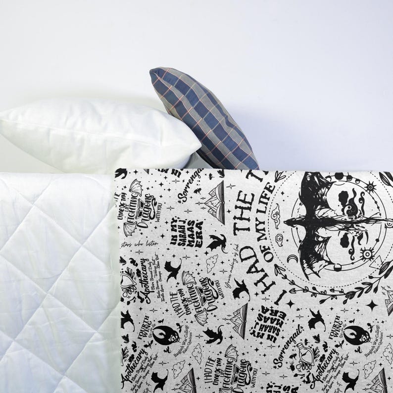 May include: A white and black patterned blanket with text and illustrations. The blanket features phrases like "I had the time of my life" and "Fighting Dragons with you." Decorative pillows are in the background.