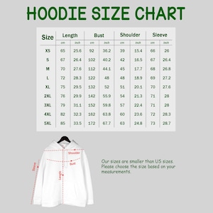 May include: A white hoodie size chart with green text titled HOODIE SIZE CHART. The table lists measurements in cm and inches for sizes XS to 5XL. Below, a white hoodie illustration shows red dashed lines indicating length, bust, and shoulder measurements.