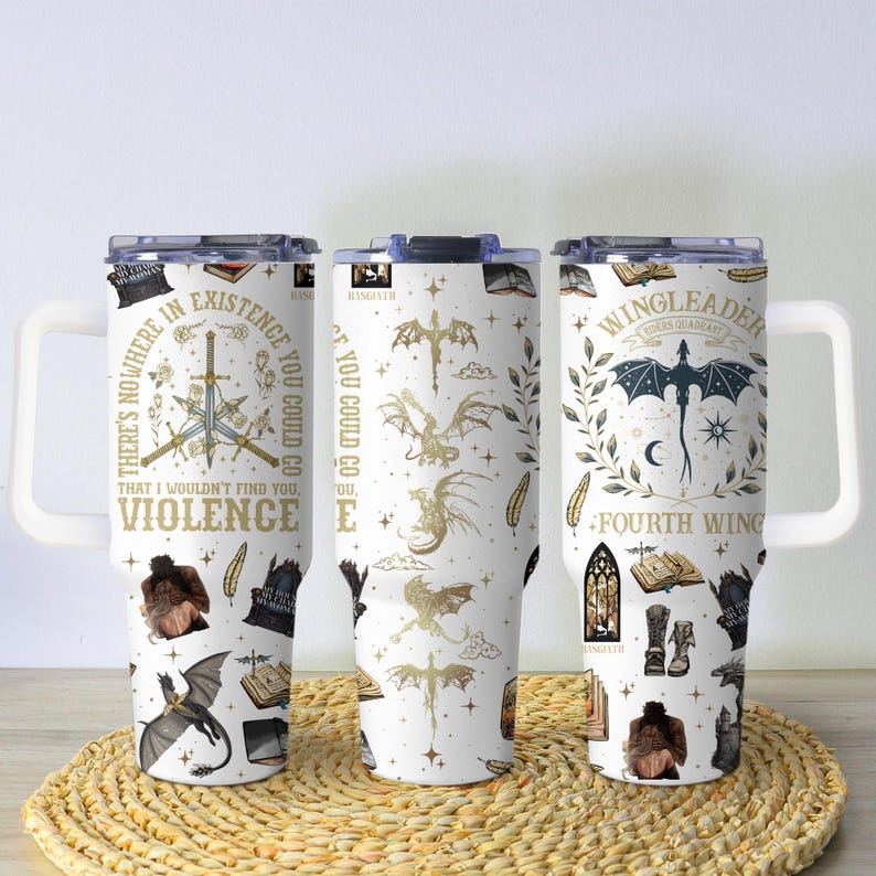 May include: Three white travel mugs with fantasy-themed designs. One mug features a sword and text that reads "THERE'S NOWHERE IN EXISTENCE THAT I WOULDN'T FIND YOU, VIOLENCE." Another mug has dragon illustrations. The third mug has a dragon and the text "WINGLEADER, FOURTH WING."