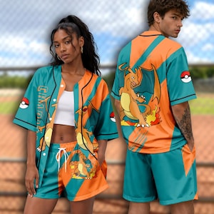 May include: A teal and orange button-down baseball jersey and matching shorts set featuring a graphic of the orange dragon-like character Charizard. The design includes Poké Ball icons and the text CHARIZARD printed vertically on the front panel.