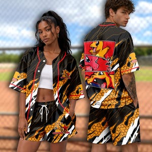 May include: A black, orange, and white baseball jersey and shorts set featuring a repeating honeycomb pattern and graphic illustrations of the character Charmander. The jersey has red piping, a button-down front, and Japanese text on the back.