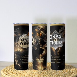 May include: Three black insulated tumblers with a fantasy theme. Each tumbler features a different design with dragons, lightning, and text that reads "FOURTH WING" and "ONYX STORM". The tumblers are approximately 8 inches tall.