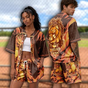 May include: A brown and orange button-down baseball jersey and matching shorts set featuring a graphic of the character Charizard, flame patterns, and a hexagonal grid design. The back of the jersey displays the text I CHOOSE FIRE.