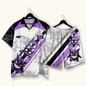 May include: A short-sleeve button-down shirt and matching shorts set featuring a purple and white graphic print of the character Gengar. The design includes diagonal black and purple stripes, a small black collar, and a rectangular patch with the text MD.