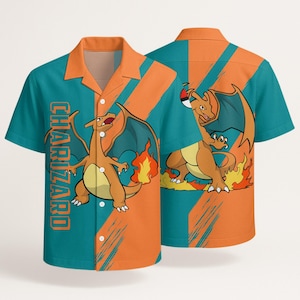 May include: A short-sleeve button-down shirt featuring a teal and orange diagonal color-blocked pattern. The shirt displays a graphic of the orange dragon-like creature Charizard with flames and the text CHARIZARD printed vertically in orange.
