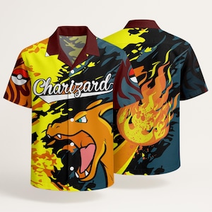 May include: A short-sleeve button-down shirt featuring a graphic of the character Charizard and flames in orange, yellow, and black. The shirt has a dark red collar, a white button placket, and the text Charizard printed in white script across the front.