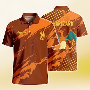May include: A short-sleeve polo shirt in shades of brown and orange featuring a graphic of the character Charizard on the back with the text CHARIZARD. The front displays a yellow silhouette of the character and the Japanese text ポケットモンスター.