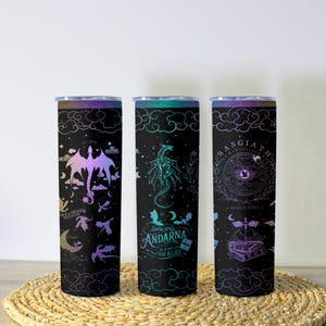 May include: Three black insulated tumblers with dragon-themed designs. One features a dragon silhouette and the text "SAVE A DRAGON RIDE A RIDER". Another has a dragon illustration and the text "ANDARNA WE DO NOT EAT OUR ALLIES". The third has a circular design and the text "BASGIATH WAR COLLEGE".