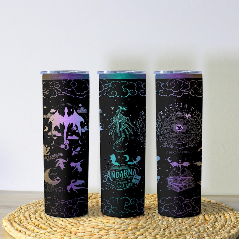 May include: Three black insulated tumblers with dragon-themed designs. One features a dragon silhouette and the text "SAVE A DRAGON RIDE A RIDER". Another has a dragon illustration and the text "ANDARNA WE DO NOT EAT OUR ALLIES". The third has a circular design and the text "BASGIATH WAR COLLEGE".