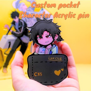 May include: A custom pocket character acrylic pin. The pin features a cartoon character with black hair and red eyes, holding a small image. The pin is set in a black pocket design with the text "Link Click" and "CXS".