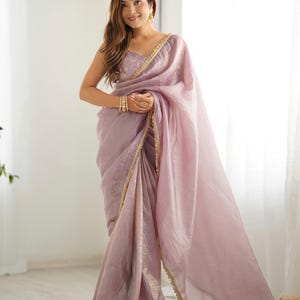 Mauve tissue embroidered saree paired with stitched blouse