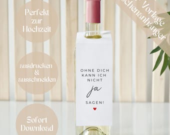 May include: A clear wine bottle with a pink cap and a white tag. The tag reads "OHNE DICH KANN ICH NICHT JA SAGEN!" with a small red heart. The image also includes text in German: "Perfekt zur Hochzeit", "ausdrucken & ausschneiden", and "Sofort Download".