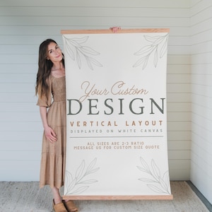May include: A large, rectangular canvas with wooden bars at the top and bottom, displaying the text "Your Custom DESIGN" in a vertical layout. The canvas has a white background with leaf illustrations. The text below reads "ALL SIZES ARE 2:3 RATIO MESSAGE US FOR CUSTOM SIZE QUOTE."