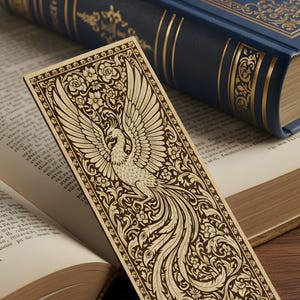 May include: A detailed wooden bookmark featuring a phoenix design with outstretched wings, surrounded by floral patterns. The bookmark is set against a backdrop of open books and a blue book with gold accents, creating a vintage aesthetic.