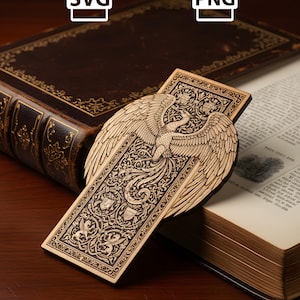 May include: A wooden bookmark with an engraved phoenix design, resting on an open book. The bookmark features intricate details and is set against a backdrop of a vintage book with gold-edged pages. The image also includes SVG and PNG file type icons.