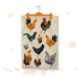 May include: A beige tea towel with illustrations of chickens and roosters in various colours. The towel is suspended from an orange hanger. The birds are depicted in shades of orange, black, green, and grey.