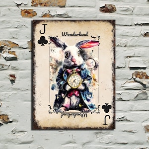 May include: A distressed metal sign depicting the White Rabbit from Alice in Wonderland as the Jack of Clubs playing card. The rabbit is dressed in a blue coat and holds a pocket watch. The word "Wonderland" is written on the top and bottom.