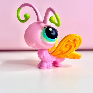 May include: A white ceramic mug with a black handle and the text "But First, Coffee" in a black, bold font. The mug is on a white surface.