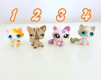 May include: Four small plastic cat figurines, each with different colored fur and markings. The cats are numbered 1 through 4.
