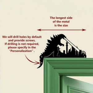 May include: A black metal wall art silhouette of Godzilla destroying a city. The text reads, "We will drill holes by default and provide screws. If drilling is not required, please specify in the 'Personalization'. The longest side of the metal is the size."