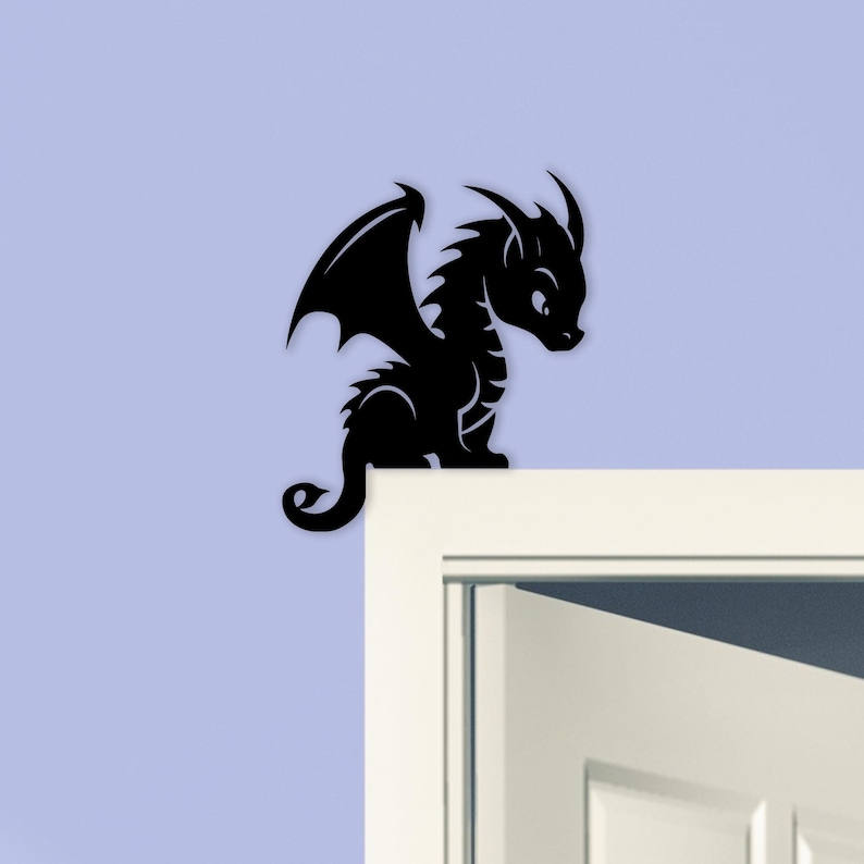 May include: A black dragon silhouette with detailed wings, horns, and a curled tail. The dragon is perched on a white surface against a light blue background. This decorative item is suitable for wall decor.