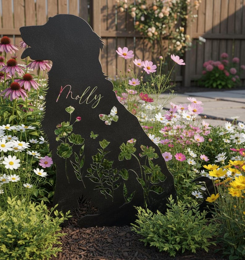 May include: Black metal dog silhouette garden stake with floral and butterfly cutouts. The name "Molly" is scripted on the dog. The stake is surrounded by colorful flowers, including pink coneflowers and daisies, in a garden setting.
